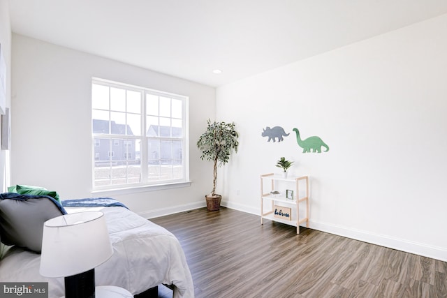 bedroom with hardwood / wood-style flooring