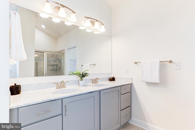 bathroom featuring lofted ceiling, an enclosed shower, and vanity