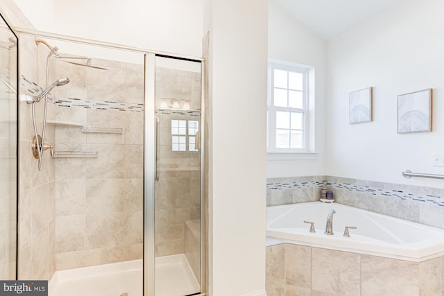 bathroom featuring shower with separate bathtub and vaulted ceiling