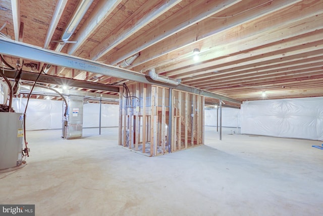 basement featuring heating unit and water heater