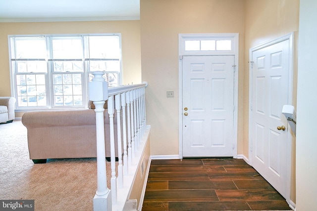 entrance foyer with crown molding and dark hardwood / wood-style floors