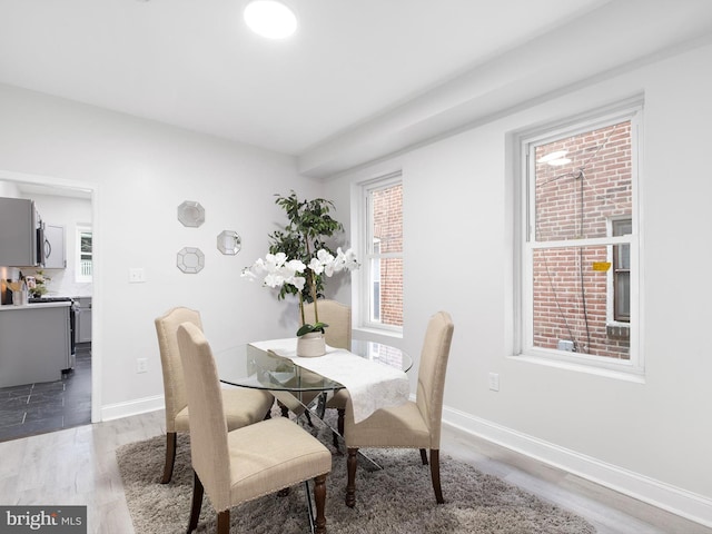 dining space with hardwood / wood-style flooring