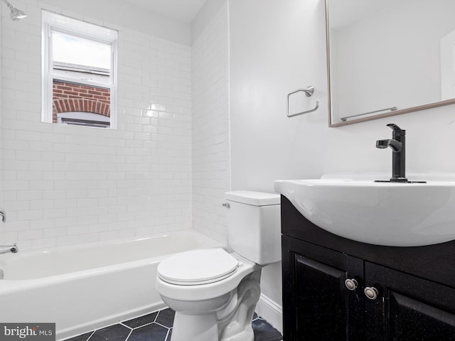 full bathroom featuring toilet, vanity, tile patterned floors, and tiled shower / bath