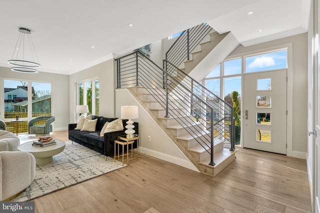 living room with light hardwood / wood-style flooring and ornamental molding