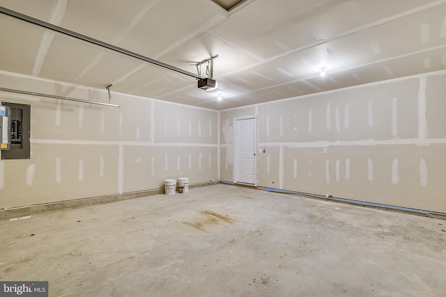 garage featuring electric panel and a garage door opener