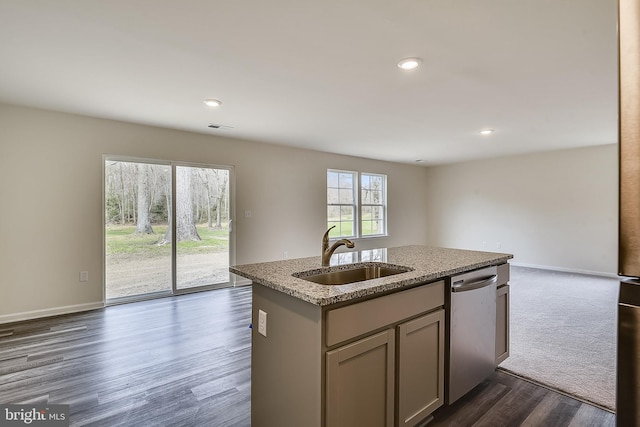 kitchen with light stone counters, sink, dishwasher, dark hardwood / wood-style floors, and an island with sink