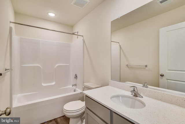 full bathroom featuring hardwood / wood-style floors, vanity, toilet, and shower / washtub combination