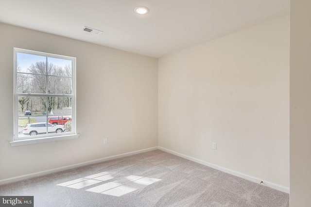 unfurnished room with light carpet