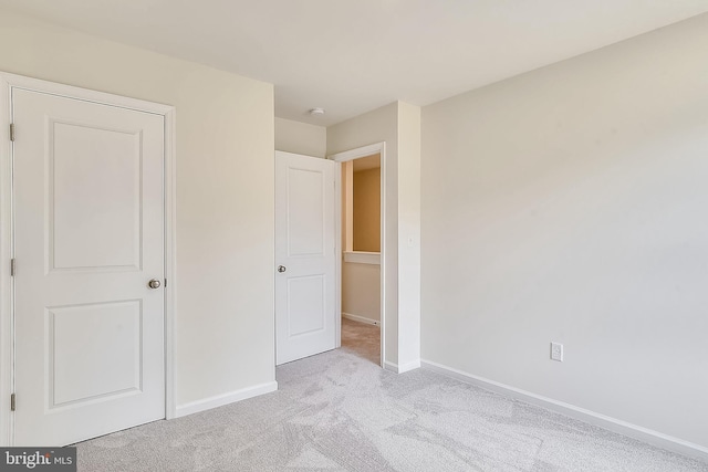 unfurnished bedroom with light carpet