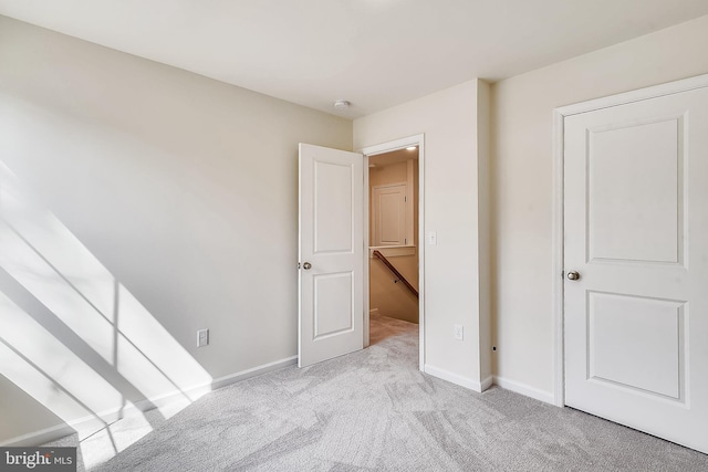 unfurnished bedroom featuring light carpet