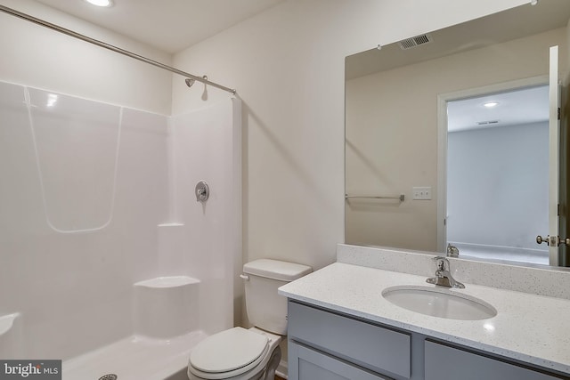 bathroom with vanity, toilet, and walk in shower