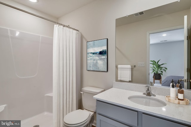 bathroom featuring vanity, curtained shower, and toilet