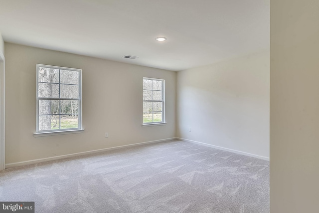 unfurnished room with light colored carpet