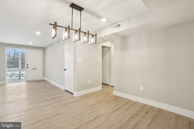 unfurnished dining area featuring light wood-type flooring