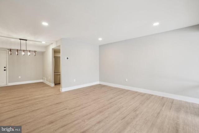 empty room with light hardwood / wood-style flooring