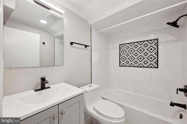 full bathroom with tiled shower / bath combo, toilet, and vanity