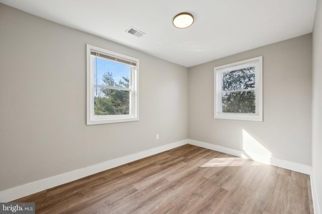 unfurnished room with light wood-type flooring