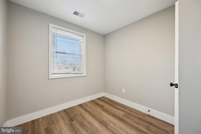 spare room with hardwood / wood-style floors