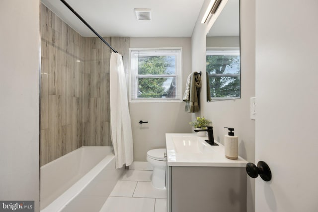 full bathroom featuring vanity, toilet, shower / bath combo with shower curtain, and tile patterned flooring