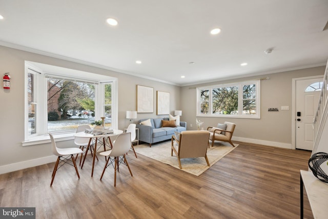 living room featuring hardwood / wood-style flooring and crown molding