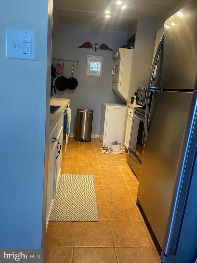 kitchen with white cabinetry, washer / clothes dryer, and appliances with stainless steel finishes