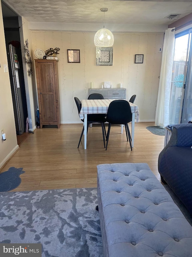 dining space featuring light wood-type flooring