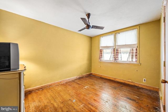 unfurnished room featuring hardwood / wood-style floors and ceiling fan