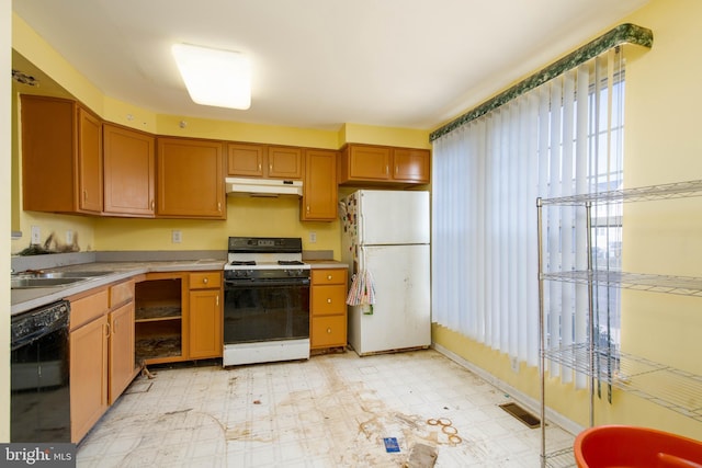 kitchen featuring white appliances and sink