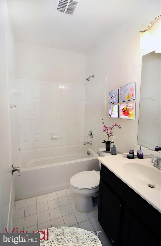 full bathroom featuring toilet, vanity, tile patterned floors, and tiled shower / bath combo