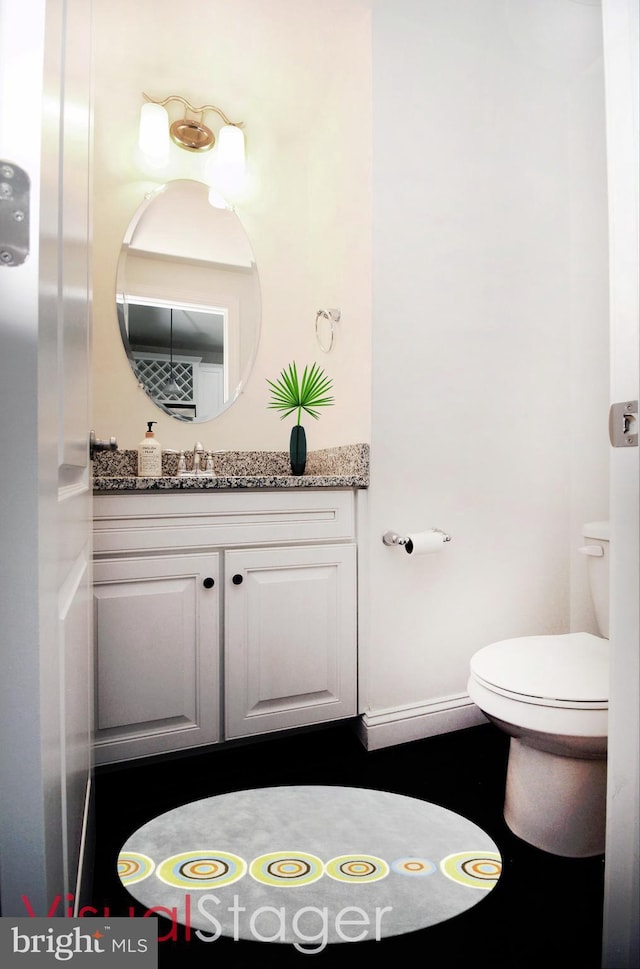 bathroom with toilet and vanity