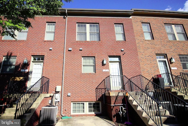 rear view of property featuring central AC