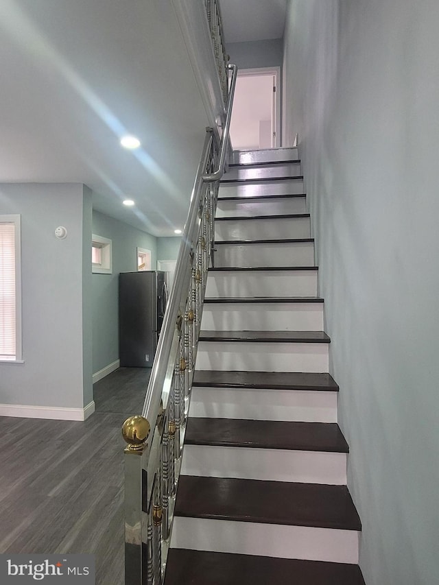 stairs featuring hardwood / wood-style floors