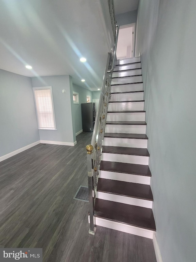 staircase with wood-type flooring