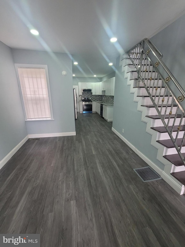 unfurnished living room with dark hardwood / wood-style floors