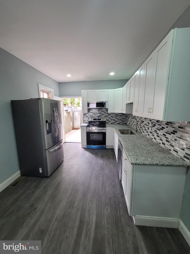 kitchen featuring white cabinetry, sink, light stone countertops, and appliances with stainless steel finishes