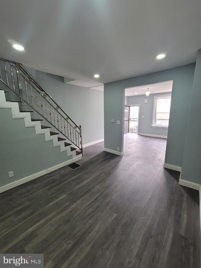 unfurnished living room featuring dark hardwood / wood-style flooring