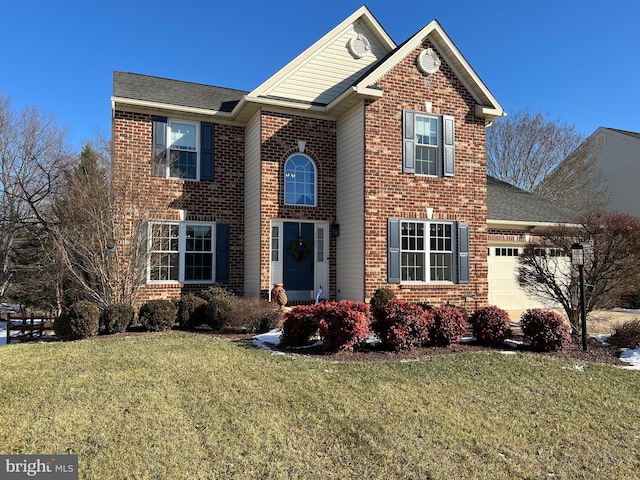 view of property with a front lawn and a garage