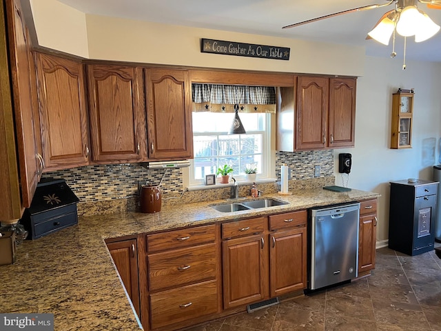 kitchen featuring sink, dishwasher, light stone counters, ceiling fan, and decorative backsplash