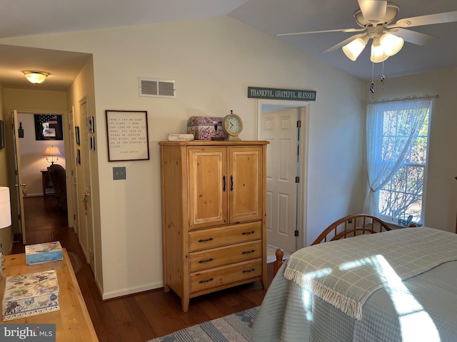 bedroom with dark hardwood / wood-style flooring, ceiling fan, and vaulted ceiling