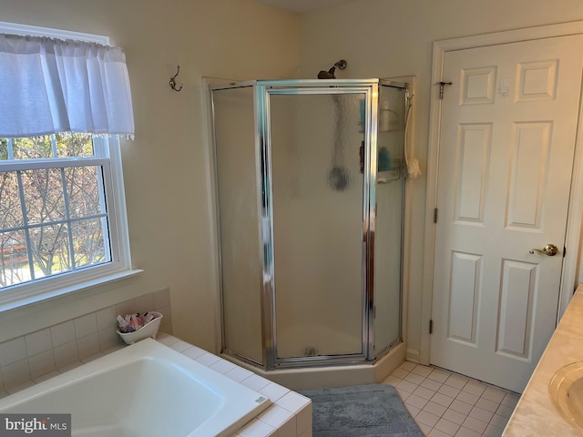 bathroom with tile patterned flooring, vanity, and shower with separate bathtub