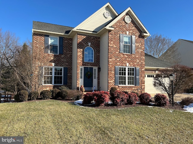 view of property featuring a front yard and a garage