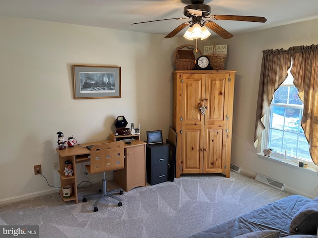 office space with ceiling fan and light carpet