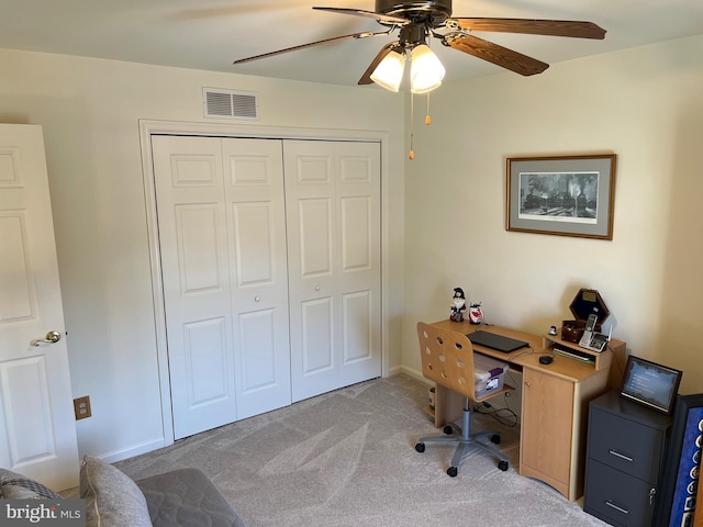 office space with light colored carpet and ceiling fan