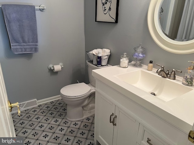 bathroom with toilet and vanity