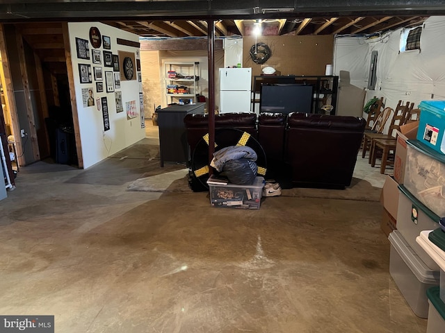 basement featuring white fridge