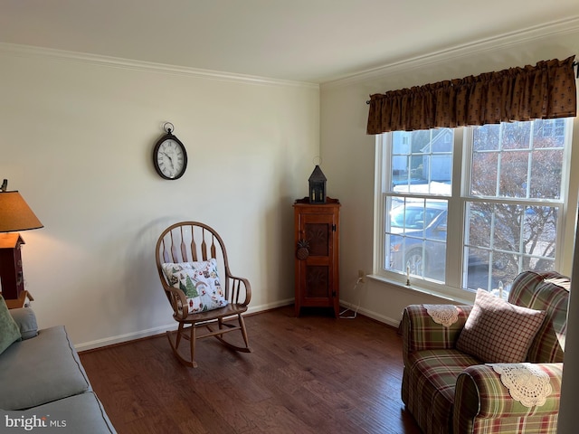 living area with a healthy amount of sunlight, dark hardwood / wood-style flooring, and ornamental molding