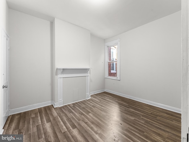 spare room featuring dark wood-type flooring