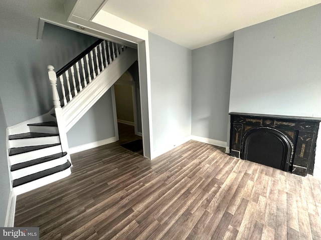 unfurnished living room featuring dark wood-type flooring