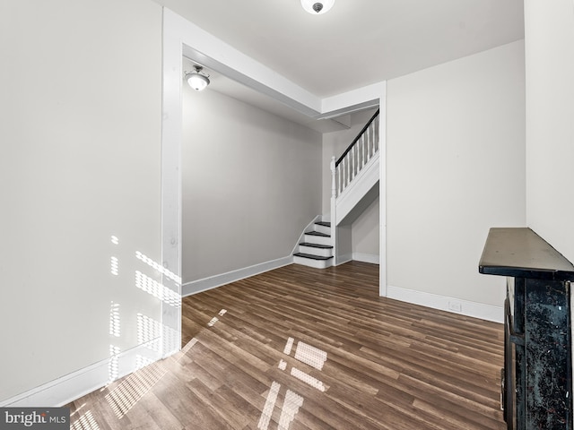 unfurnished living room featuring dark hardwood / wood-style flooring