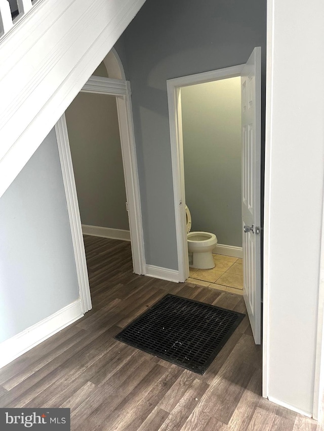 bathroom featuring hardwood / wood-style floors and toilet